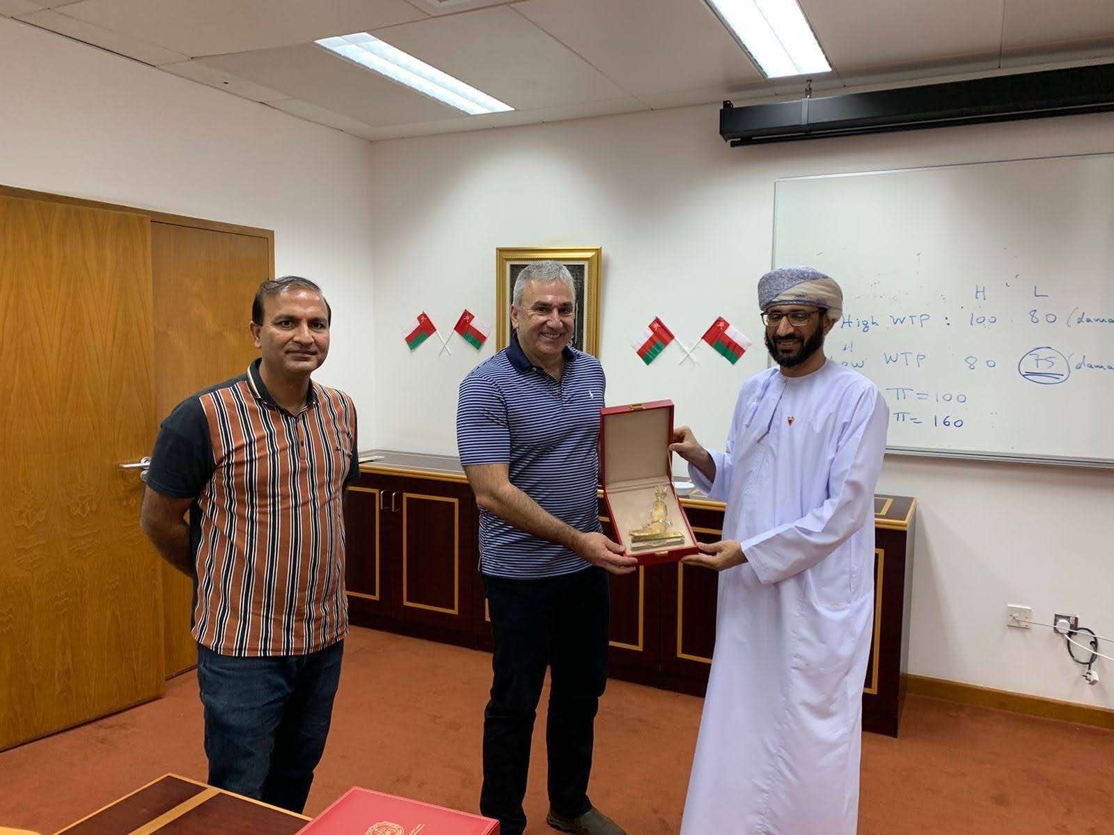 After the seminar and lecture at Sultan Qaboos University, Muscat, Oman, 2021. As a token of appreciation, I am being offered a gift from the Dean of the Business School, Dr. Almukhtar Saif Al-Abri. Dr. Ahmad Nisar is standing on my right.